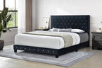 A black fabric velvet diamond-shaped queen bed with crystal tufting, displayed in a room setting with bedding and a nightstand.
